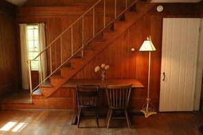 Staircase from Living Room to two Upstairs Bedrooms. The table pictured can be pulled out as an additional dining table. We have additional chairs throughout the space that can be used