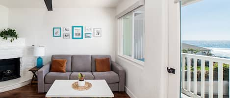 Partial ocean view living room with original 1940s fireplace (gel fuel provided for guest use)