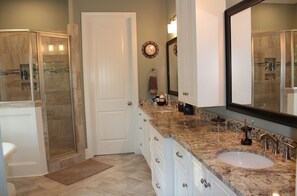 Owner's bath with walk-in shower, garden tub, and oversized walk-in closet.