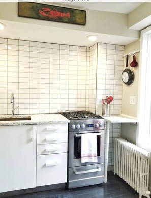 Kitchen includes pots/pans, plates, utensils, microwave, fridge, coffee maker.