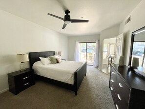 Master bedroom with sliding doors that lead to a private porch.