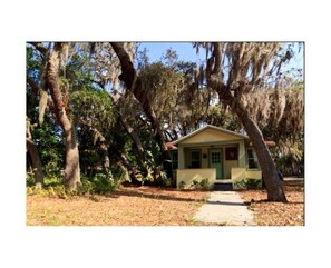 The house is nestled in a canopy of live oaks covered in Spanish Moss.