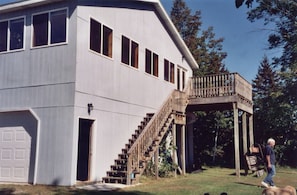 Upper level 3 bdrm house view of stairway to deck entrance-steps from lake
