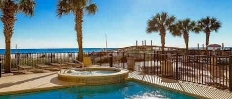 Swim through pool that is heated in cooler months. Hot tub with beach view.