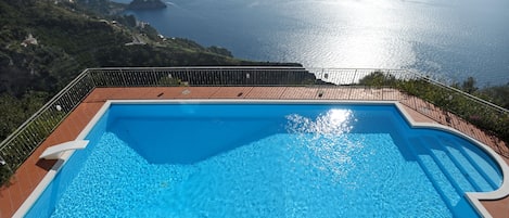 The wonderful pool with open views of coast and sea