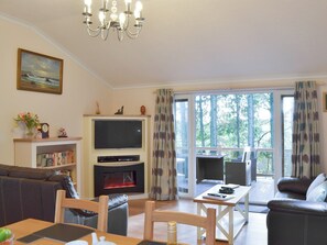 Comfortable living area with doors to the veranda | Oak Lodge, Clatworthy, near Williton