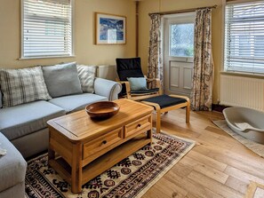 Living room with oak flooring  | Trinity Cottage, Wells-next-the-Sea