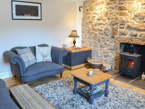 Lovely living room with feature stone wall | Wallace House, Dornoch, near Tain