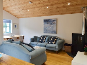 Open plan living space with beams and wooden floor | Eagle Owl Lodge, St Columb Major, near Padstow