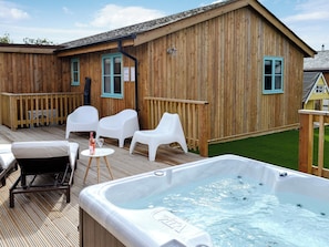 Extended decking areas with loungers and hot tub | Eagle Owl Lodge, St Columb Major, near Padstow