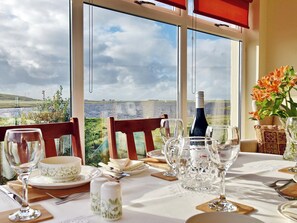 Lovely dining room taking advantage of the stunning views of Loch Roag | Padraig’s Cottage, Howbeg (Tobha Beag), Isle of South Uist