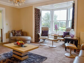 Spacious living room with wood burner | Maesbangor Farmhouse - Maesbangor, Capel Bangor, near Aberystwyth