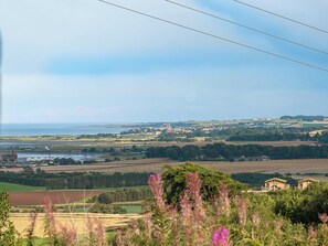 Window seat offering panoramic views across the surrounding farm lands to St Andrews Bay | Lucklaw Steading Cottage, Balmullo, near St Andrews
