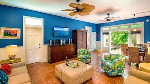 Americana Tropicale - The living room features a large flat screen TV...