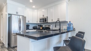 The complete kitchen is stylish in black and white.