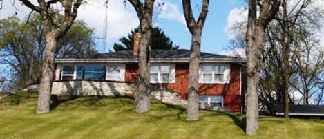 The Red Brick Estate with well manicure lawn and bright sunny views to the lake.