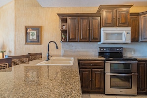 The large kitchen counter and appliances.