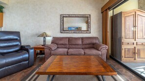 Sofa and recliner in the living room, right by the patio.