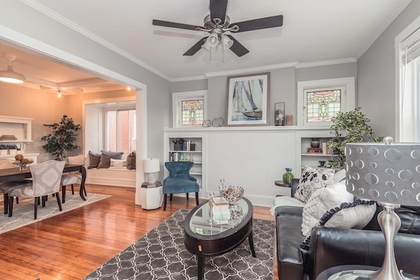 Living Room with built-in bookcases and stain glass windows