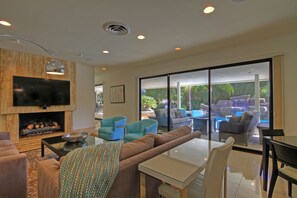 Living Room with 65 in TV and large sliding door lets room flow to the outdoors!