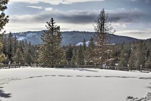 This vacation rental cabin boasts a private deck with stunning property views.