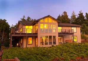 This incredible 5000-square-foot lake house features decks and covered porches.