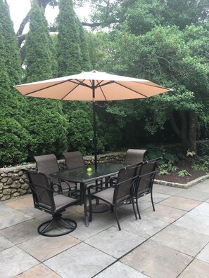 Cool off with a beverage or dinner on shaded patio at kitchen back door.