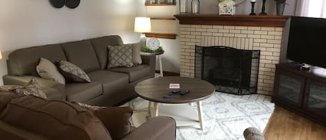 Living room with comfortable seating for six guests.