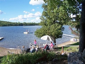 Beautiful Sandy Beach with sitting area, dock, and swimming raft!