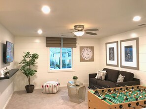 Entertainment loft area with a foosball table