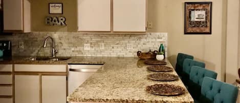 New kitchen with granite counter tops.