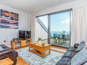 Living area with sliding doors to the balcony | Sand Dunes - Nassau Court, Westward Ho!