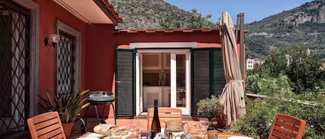  The nice terrace with dining table, umbrella, and shower.