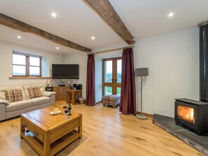 Delightful living room with a cosy wood burner | Ysgubor, Pwllglas, near Ruthin