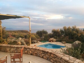 View from veranda, looking over the pool towards hills distant mountains and sea