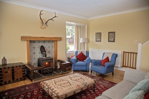 Large open plan living area with woodburner.