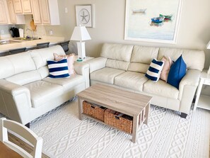 New LVP flooring and leather couches in living room.