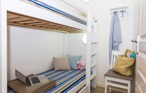 The cozy sleeping alcove contains a bunk bed.