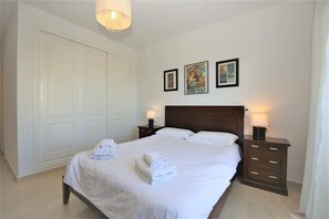 Master bedroom with king size bed, air conditioning and wardrobe space