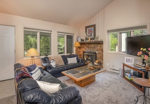 Cozy living room with wood burning fireplace, Cable TV and Apple TV.