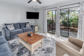 Living room opens up to expansive patio with swing