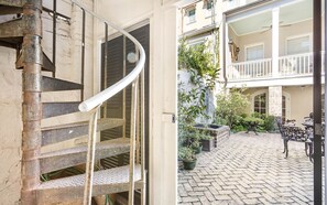 A wrought iron staircase leads directly up to your unit.