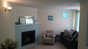 Living Room w Fireplace, Couch, Chair, and Wrought Iron Table & Chairs