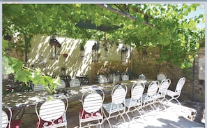 Outdoor shady seating under the vine covered pergola seats18-20