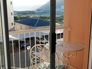 Balcony with garden furniture with a view of beach and mountains