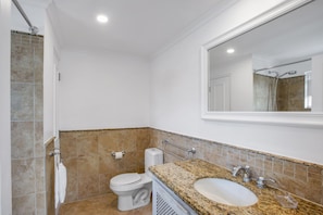 En-suite bathroom with shower-bath combination.
