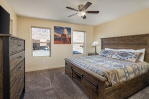 Spacious master suite with beautiful rustic furnishings, a comfortable king size bed, attached bath and views of the Moab Rim.