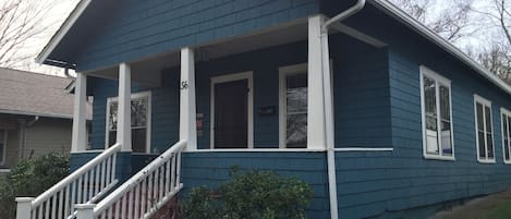 Front Porch with two seat bistro table and porch swing looks to the East.