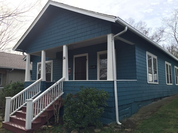 Front Porch with two seat bistro table and porch swing looks to the East.