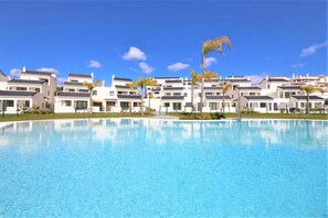 Inviting community swimming pool surrounded by beautiful Mediterranean gardens (temporary picture)